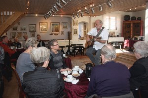 Helge Engelbrecht underholder med guitar og sang 